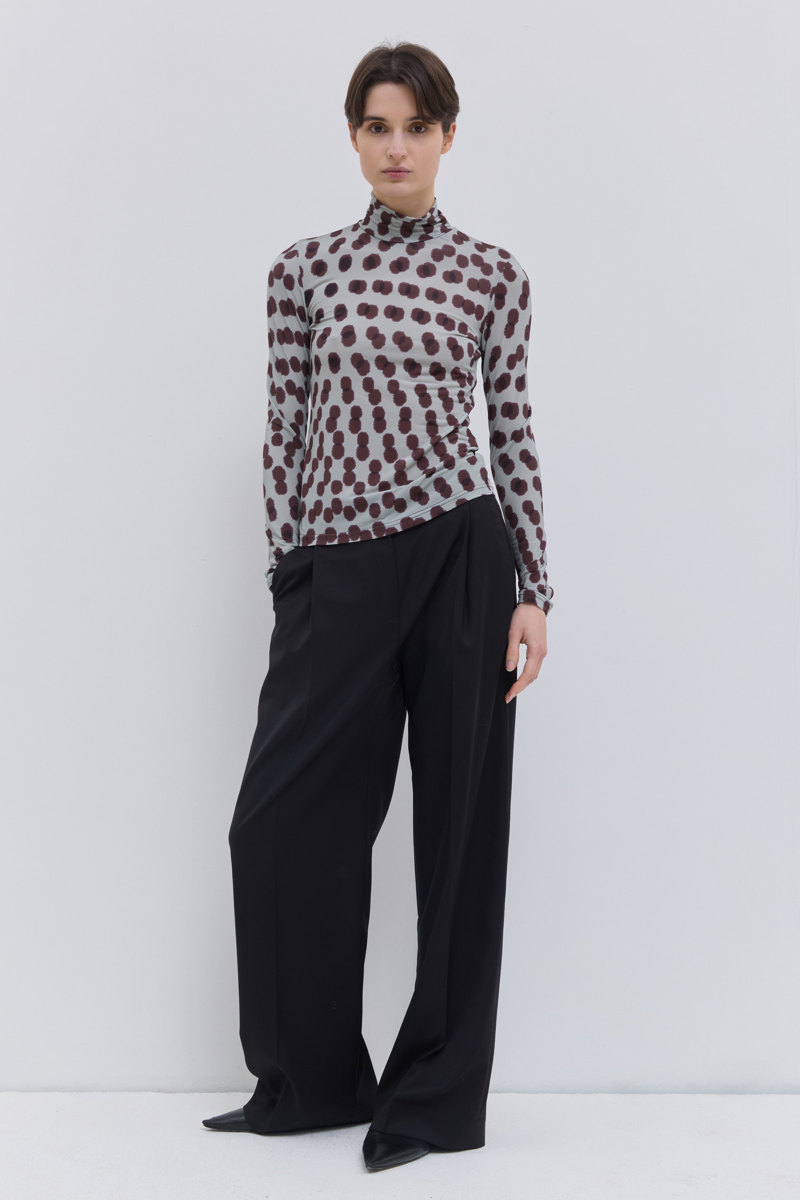 Front view of the Tugal turtleneck top in plum polka print stretch jersey.
