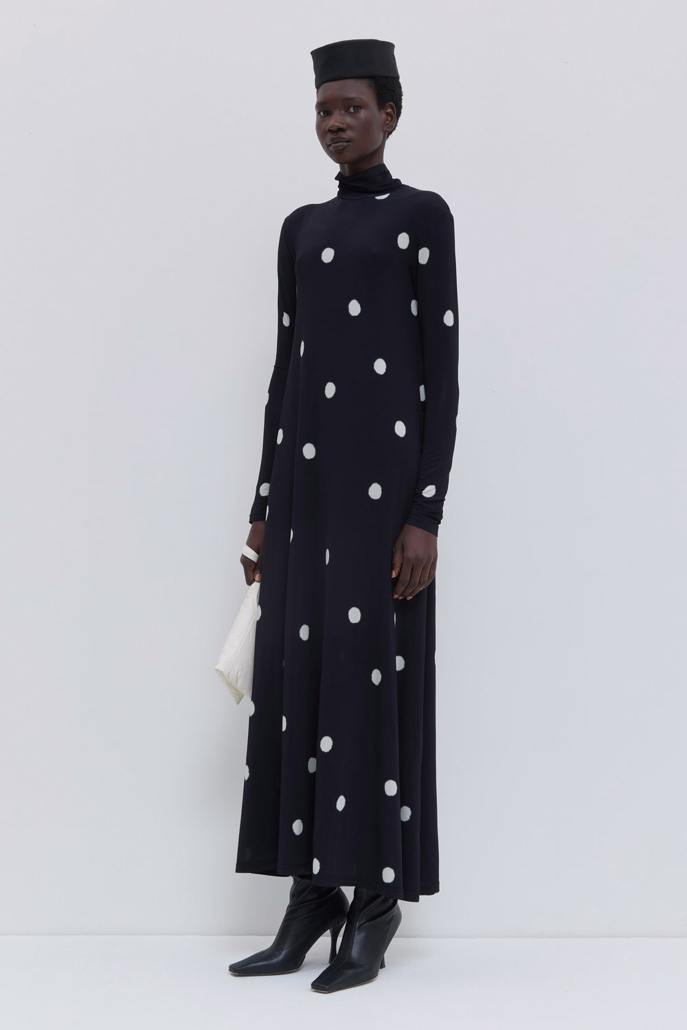 Black long-sleeve maxi dress with large white dot print, turtleneck neckline and fluid jersey construction by Christian Wijnants.