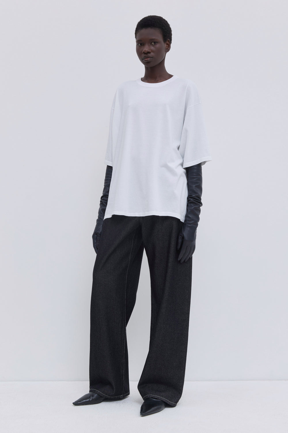 Front view of a white 100% cotton oversized jersey knit T-shirt with relaxed fit.