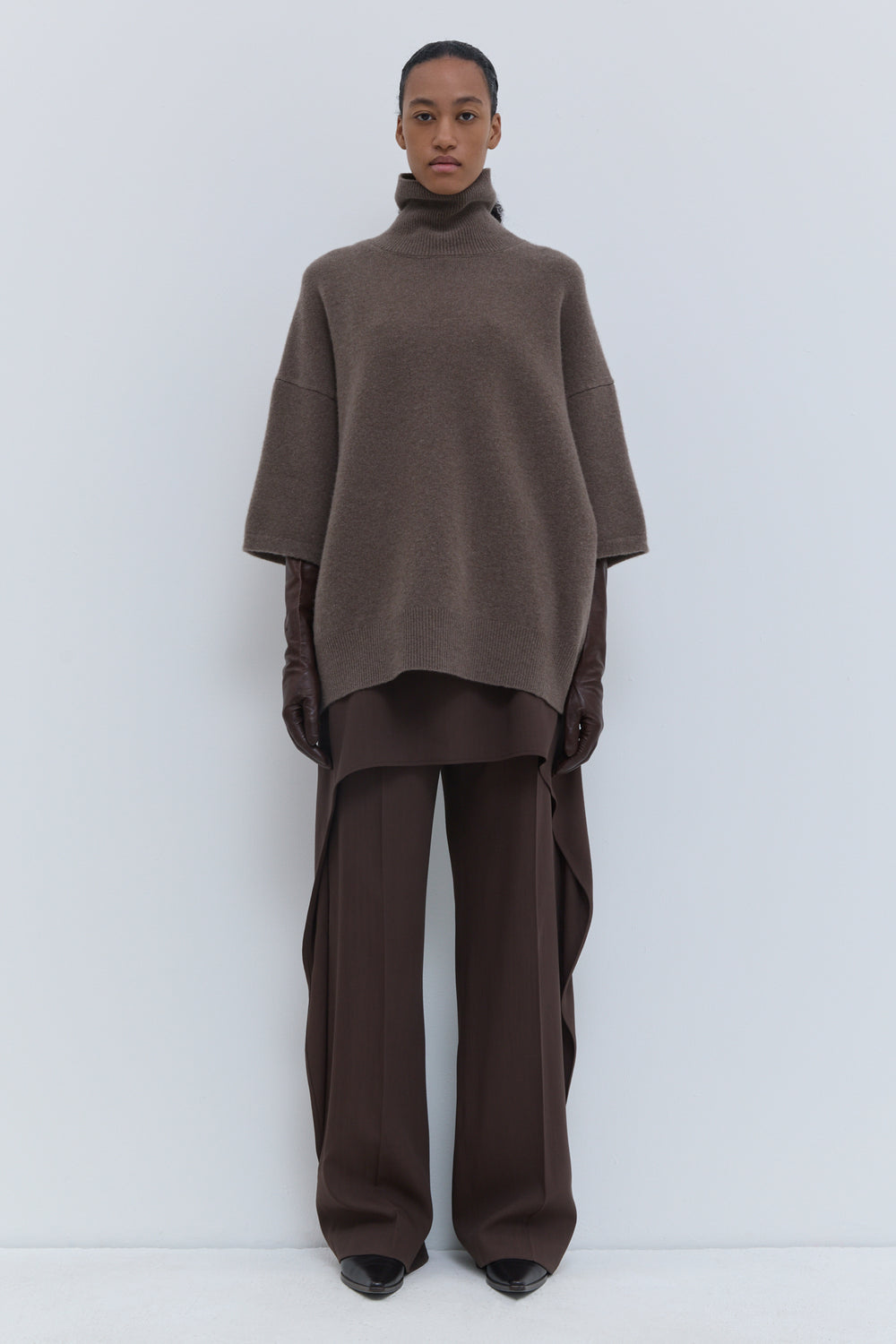 Brown melange oversized turtleneck knit with wide sleeves and relaxed silhouette