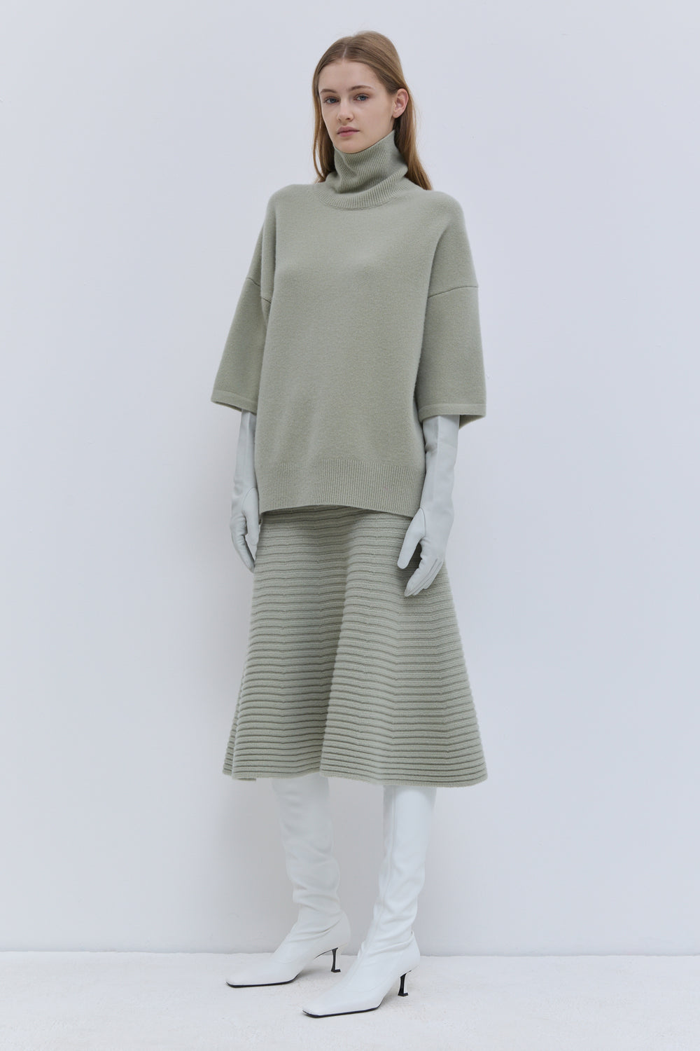 Koyo light sage oversized knitwear top styled with brown skirt