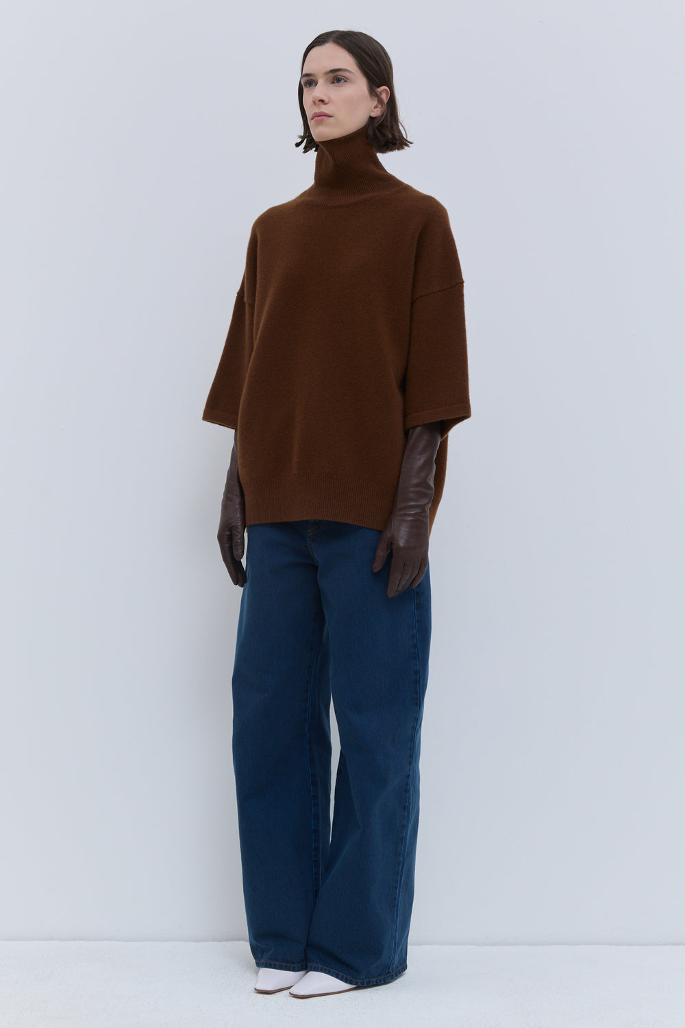 Rust oversized turtleneck knit with wide sleeves and relaxed silhouette