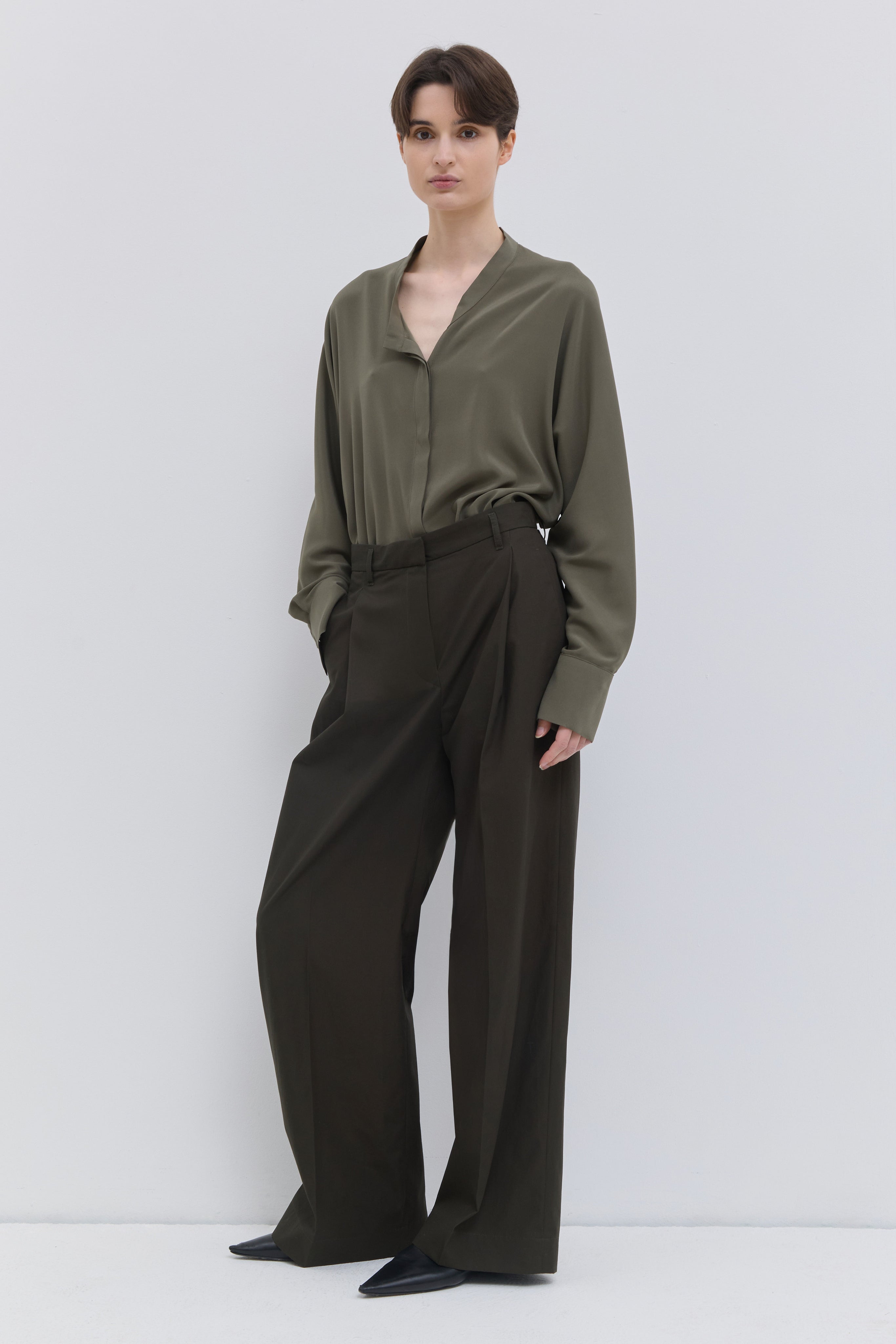 Classic deep forest cotton trousers with pressed front creases.
