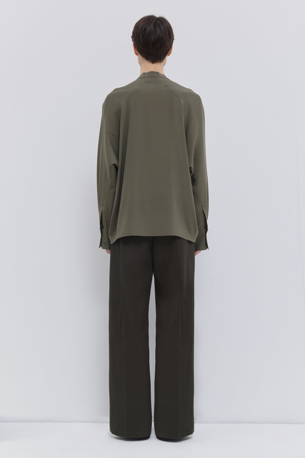 Luxury deep forest cotton trousers with a wide-leg fit and tailored front creases by Christian Wijnants.