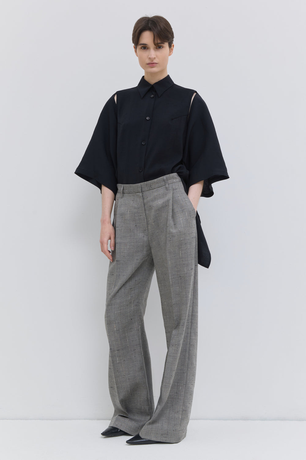 Side view of the Pama wide-leg trousers in oat chartreux styled with a chunky knit sweater.