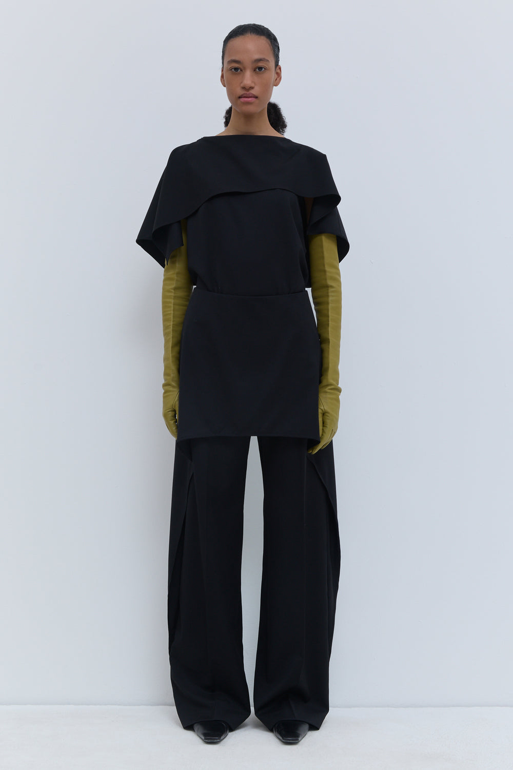 Christian Wijnants black virgin wool wide-leg trousers with layered skirt overlay, shown from the front