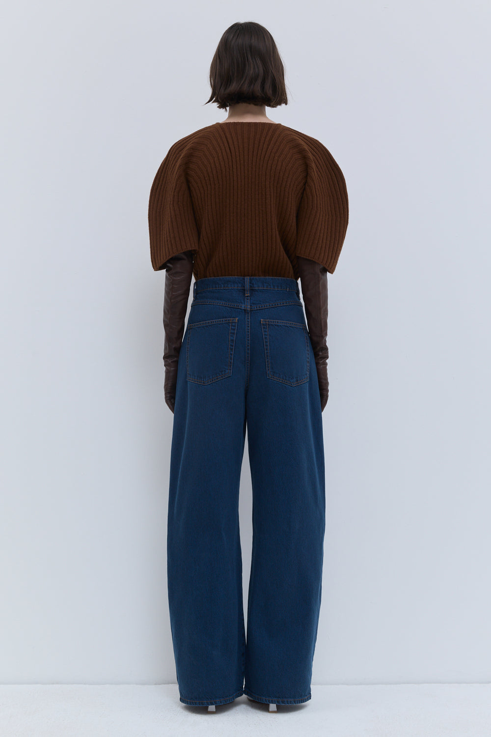 Back view of Pullos wide-fit jeans in blue wash denim, highlighting the relaxed straight silhouette and full-length wide leg.