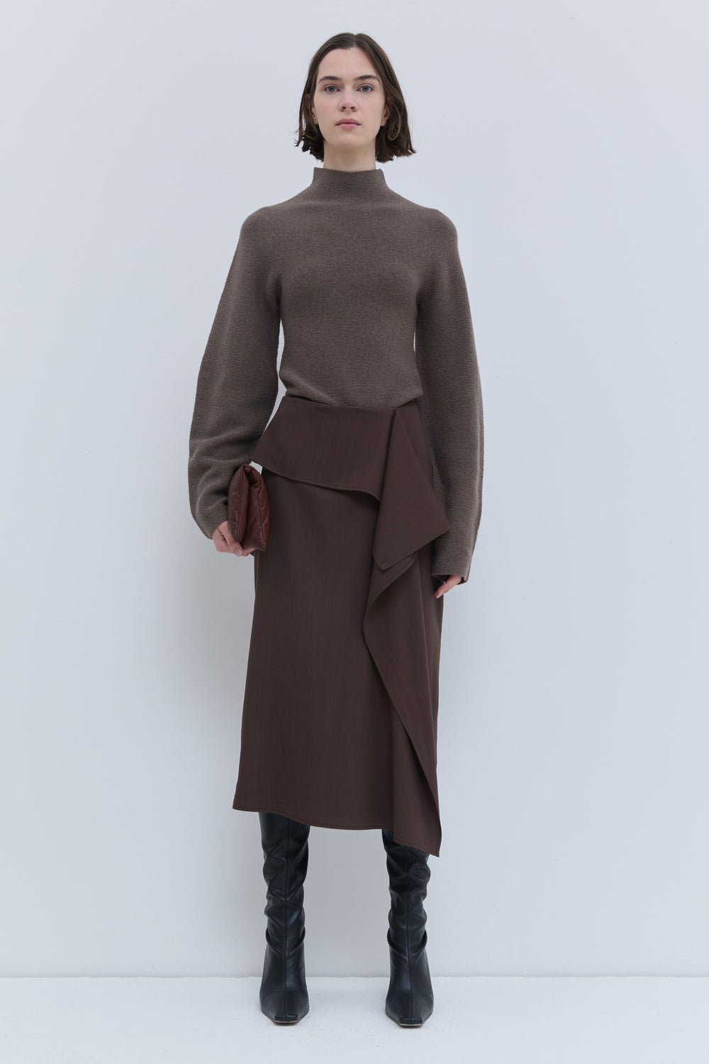 Christian Wijnants Sailo chestnut skirt with sculptural draped front panel, side view.
