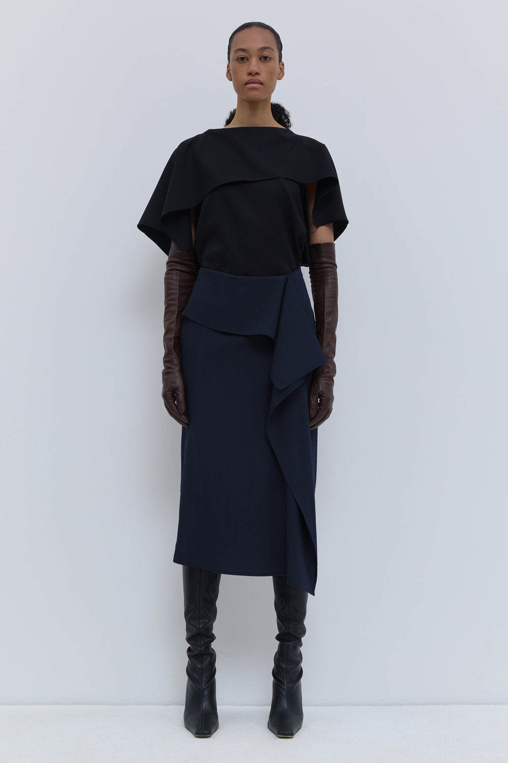 Christian Wijnants Sailo dark navy skirt with asymmetric front drape, front view.