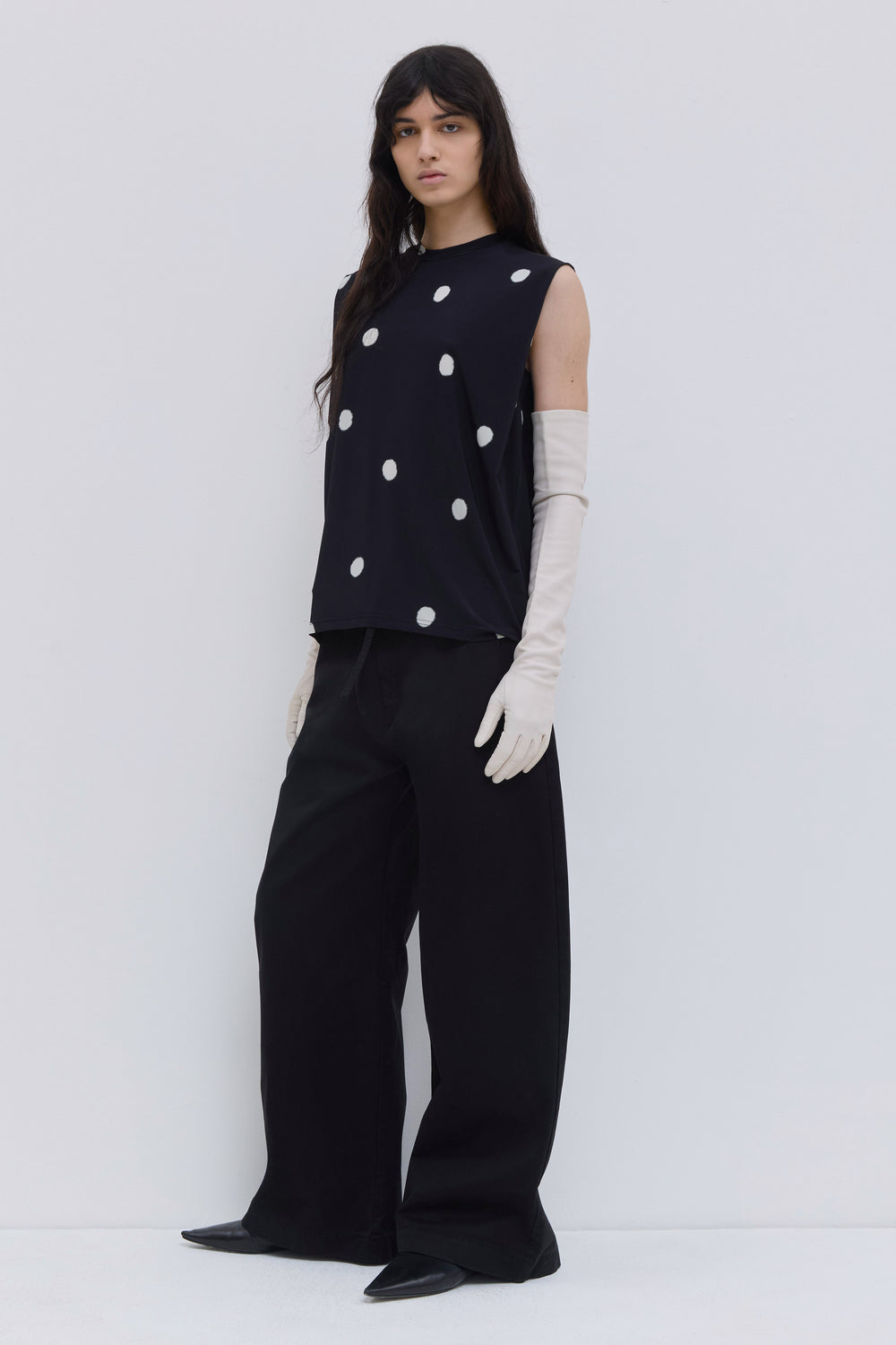 Black sleeveless jersey top featuring an oversized dot print, round neckline and fluid silhouette by Christian Wijnants.