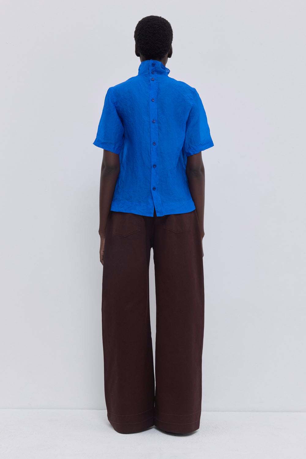 Cobalt blue silk organza blouse with a high neckline, short sleeves and artisanal crushed texture by Christian Wijnants.