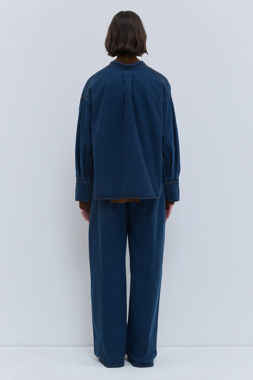 Taroski blue wash denim top, back view showing the relaxed fit and wide sleeves.