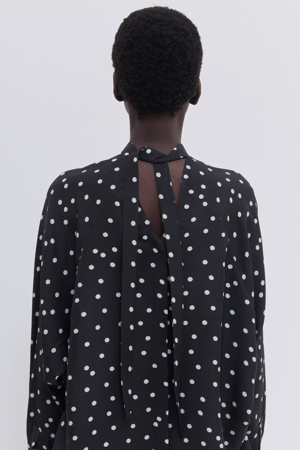 Relaxed fit designer blouse with versatile tie-neck detail